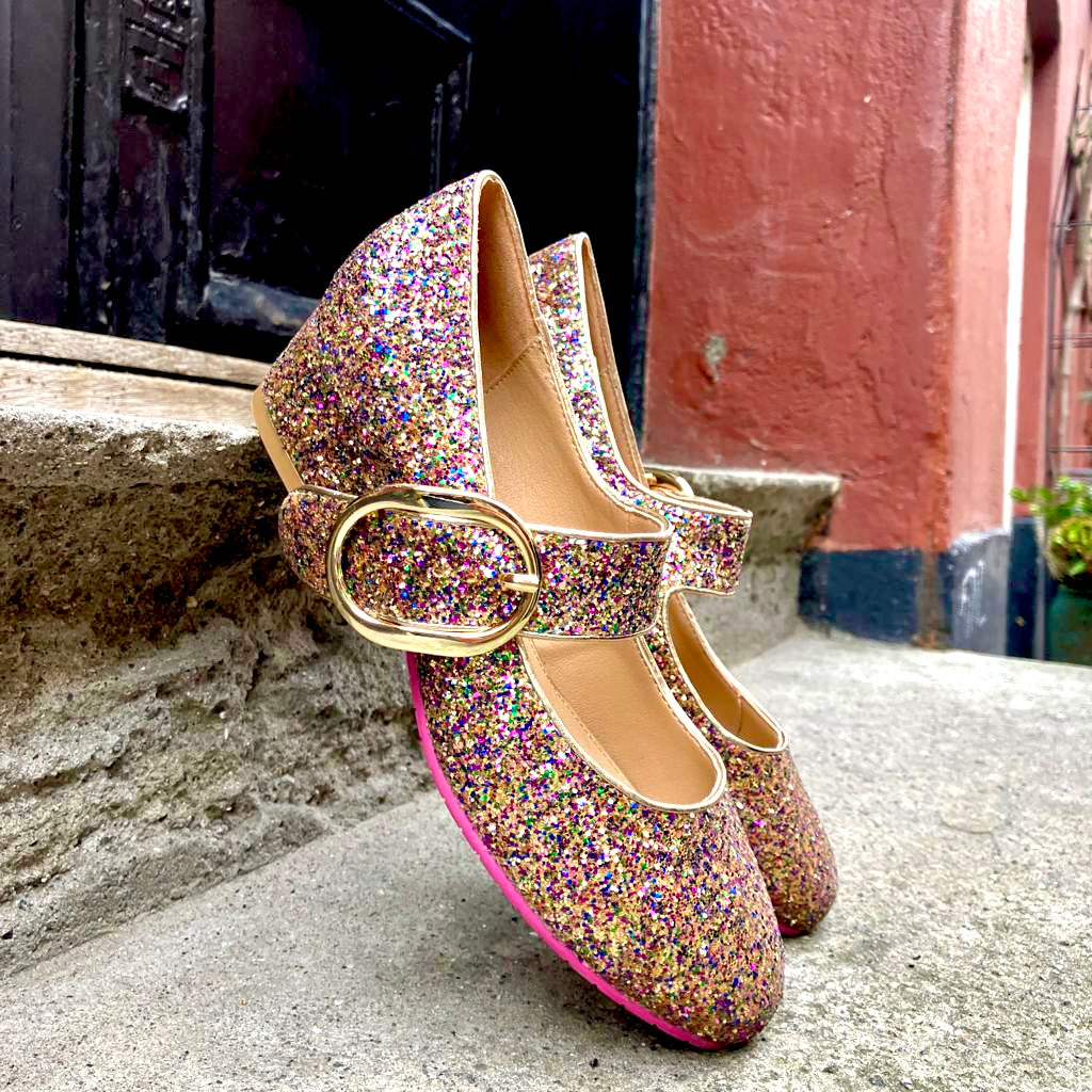 mary jane pump in ulti glitter materials and with a strap across the foot and a gold buckle