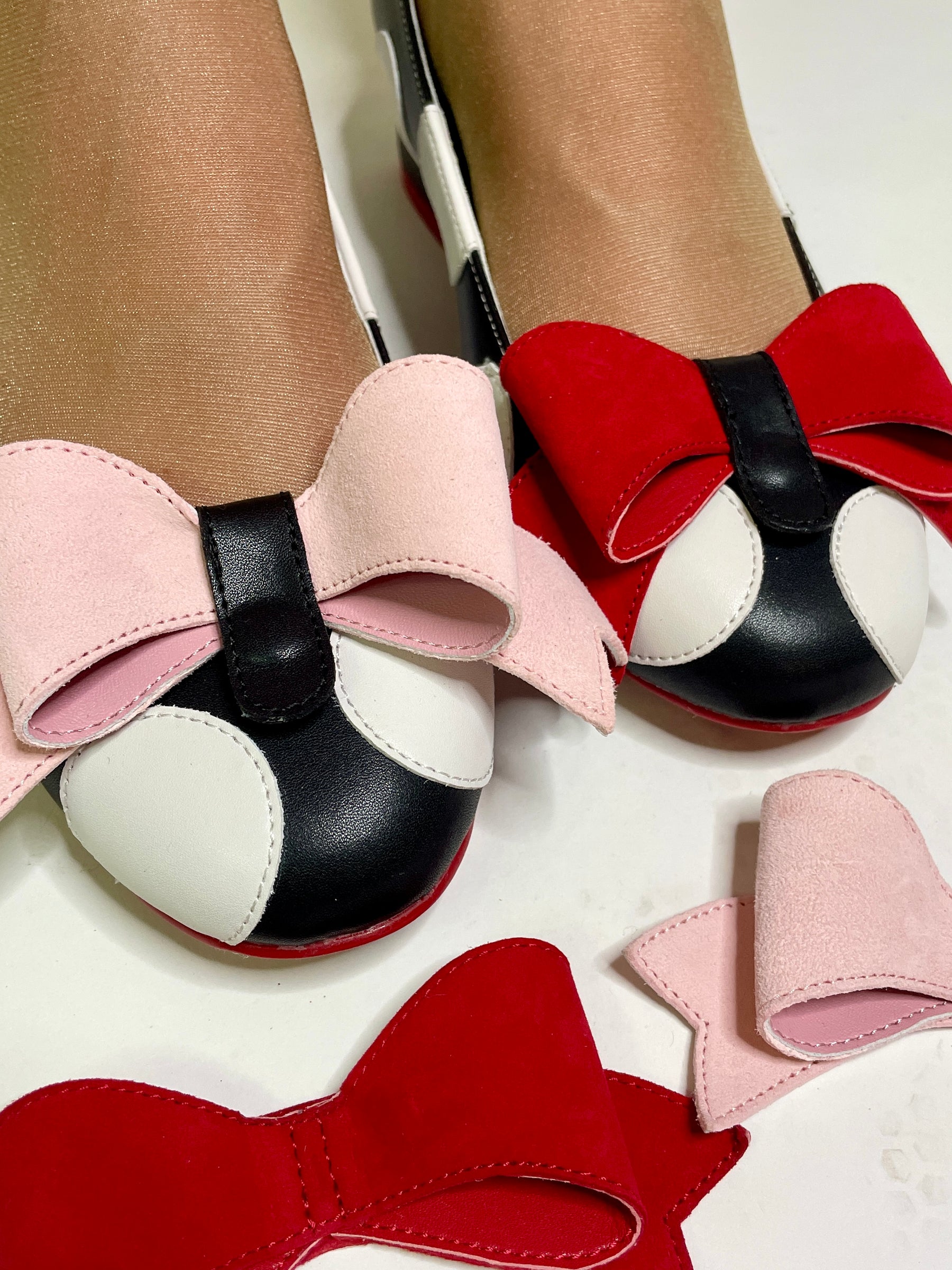 Colorful shoes with large bows on a white background