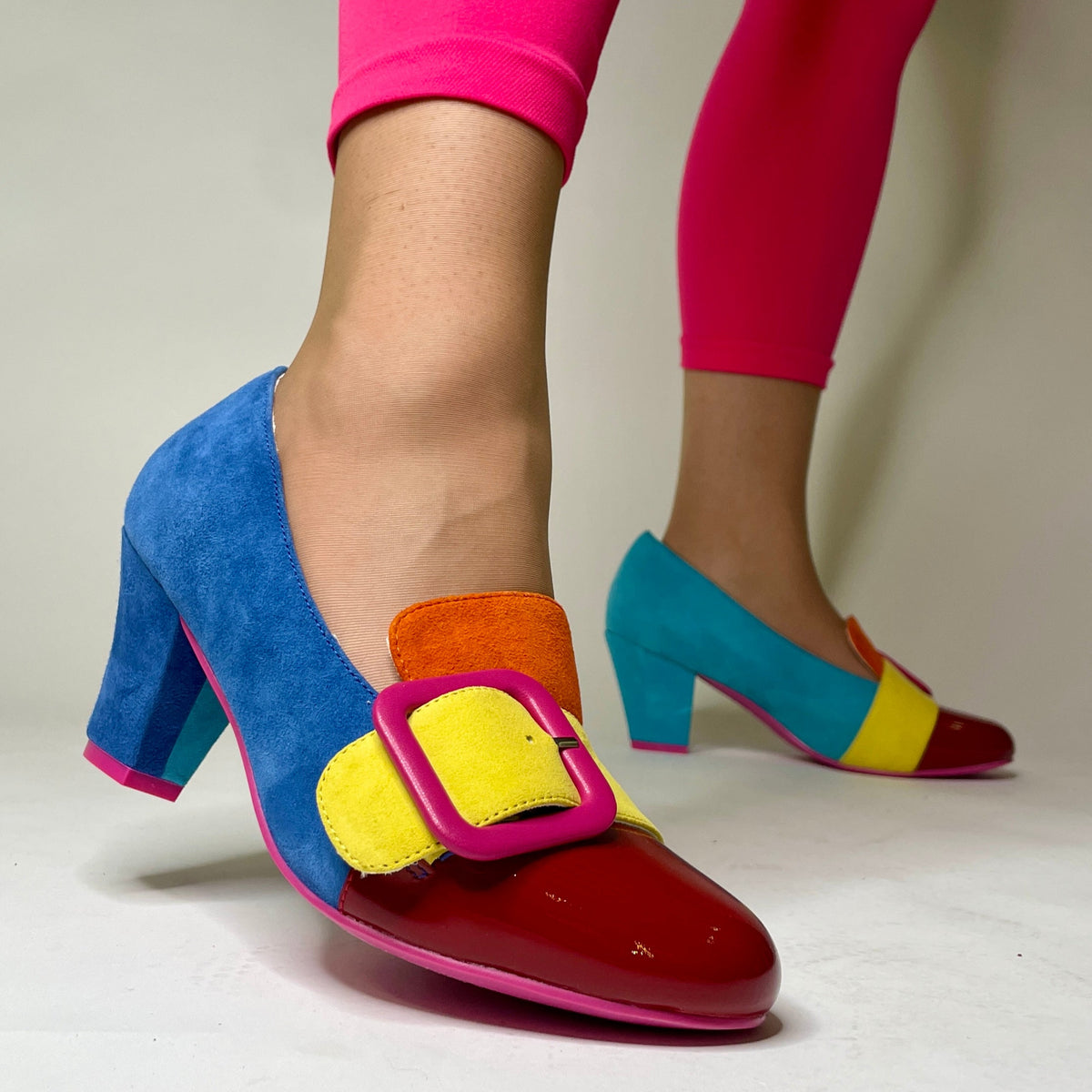 Colorful high-heeled shoes with a unique design on a neutral background